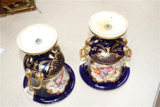 A pair of Victorian Derby style campana vases, painted with panels of flowers within gilt cobalt blue borders, unmarked, height 20cm